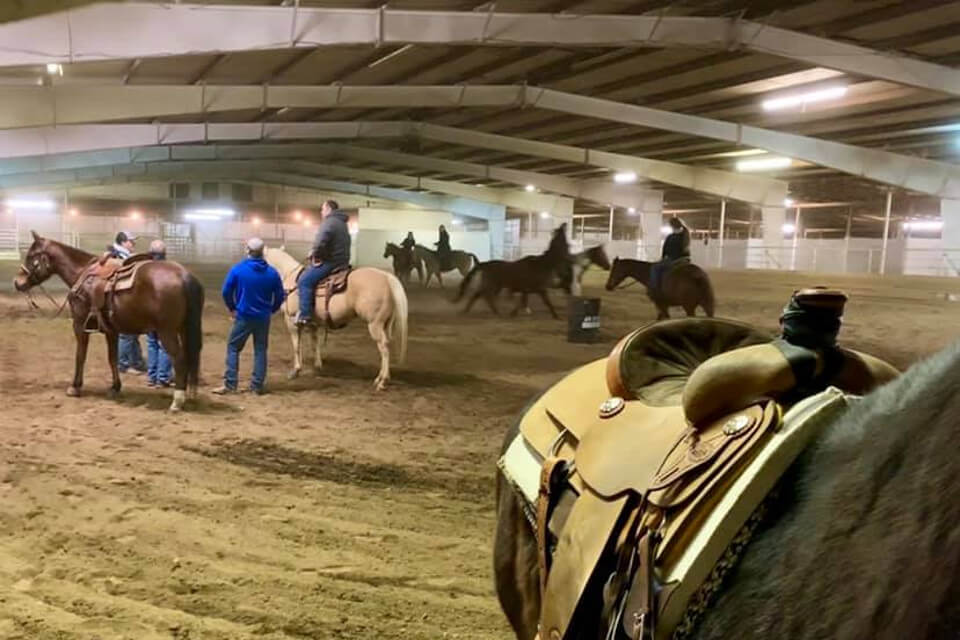 Riders and horses inside Civil War Arena